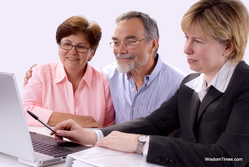 Mature couple talking to financial planner at home